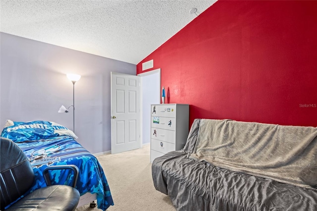 bedroom with carpet, a textured ceiling, and lofted ceiling