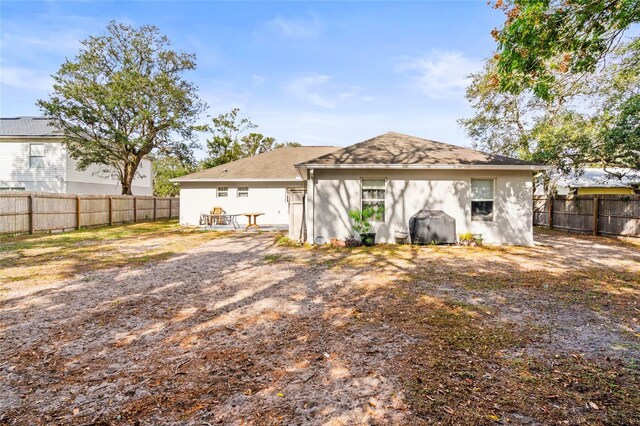 2102 Deltona Blvd, Spring Hill, FL 34606 - rear view of house with a fenced backyard and stucco siding