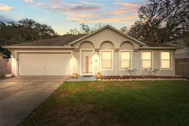 ranch-style house with a lawn and a garage