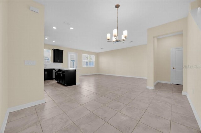 interior space with light tile patterned flooring and an inviting chandelier