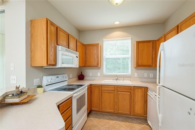 kitchen with light tile patterned floors, white appliances, and sink