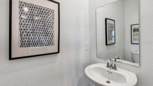 bathroom featuring sink and toilet