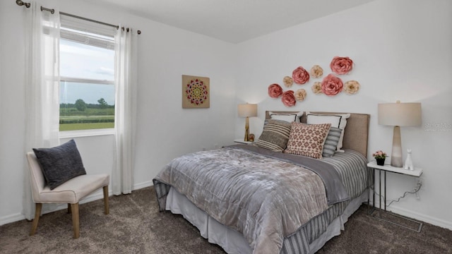 bedroom featuring dark carpet