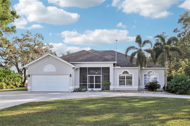 ranch-style house with a sunroom, a garage, and a front lawn