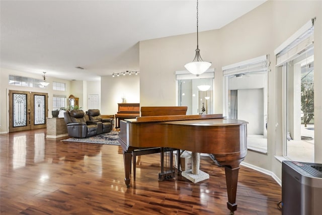 miscellaneous room with french doors, rail lighting, and hardwood / wood-style flooring