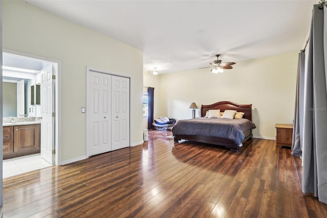 bedroom featuring ensuite bath, ceiling fan, and dark wood-type flooring