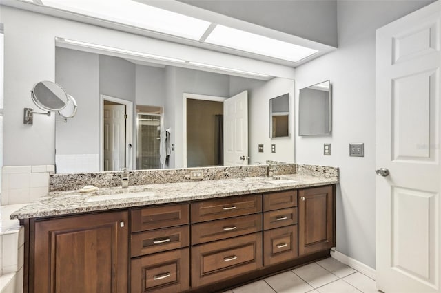 bathroom featuring tile patterned floors, vanity, and an enclosed shower