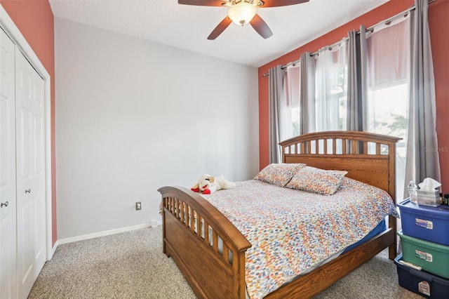 bedroom with ceiling fan, a closet, and carpet