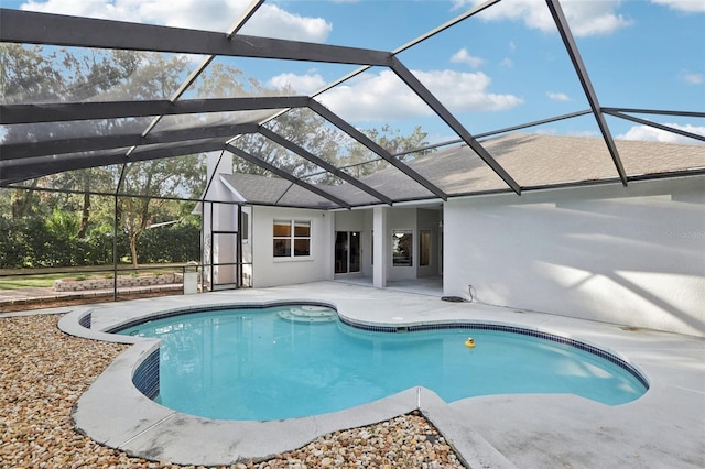 view of swimming pool with a lanai and a patio