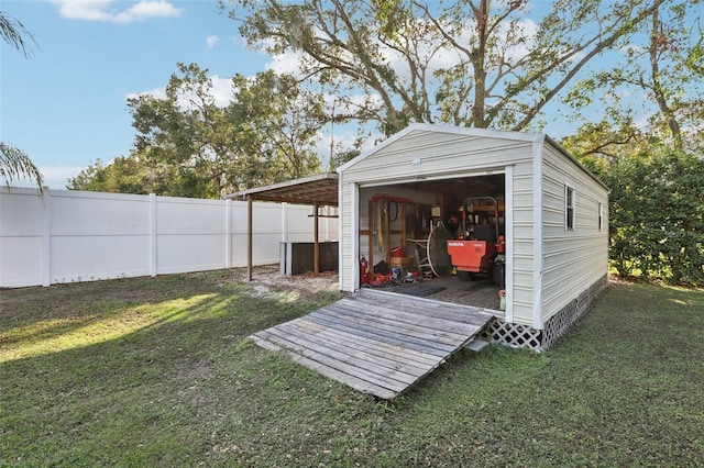 view of outbuilding with a carport and a lawn