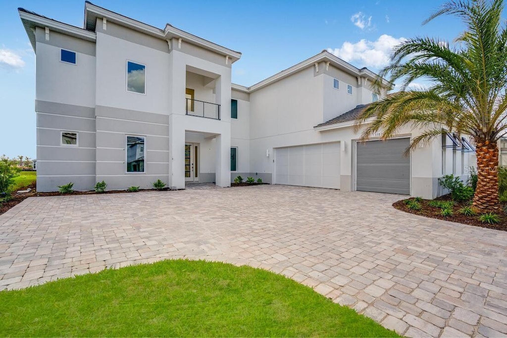 view of front of property with a garage and a balcony