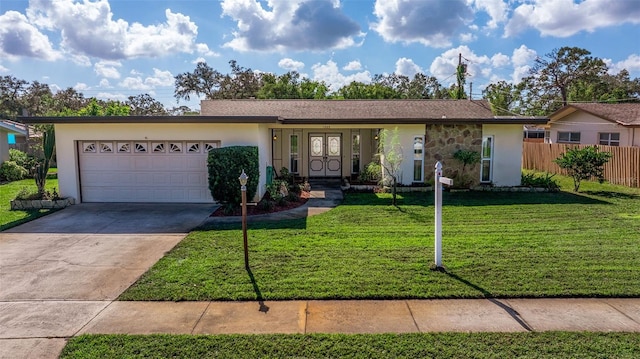 ranch-style house featuring a front lawn and a garage