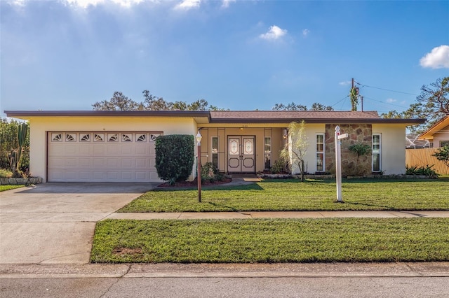 ranch-style house with a front yard and a garage