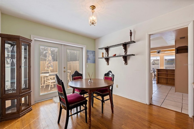 dining room with french doors and light wood-type flooring