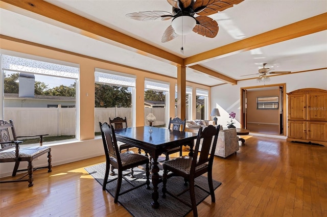 dining room with hardwood / wood-style floors, beamed ceiling, and ceiling fan