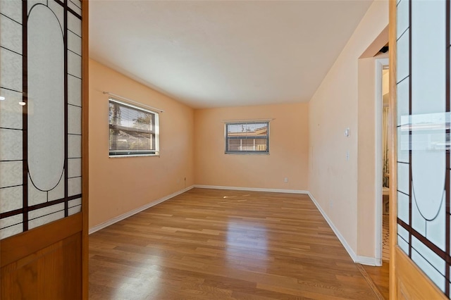 spare room with light hardwood / wood-style flooring