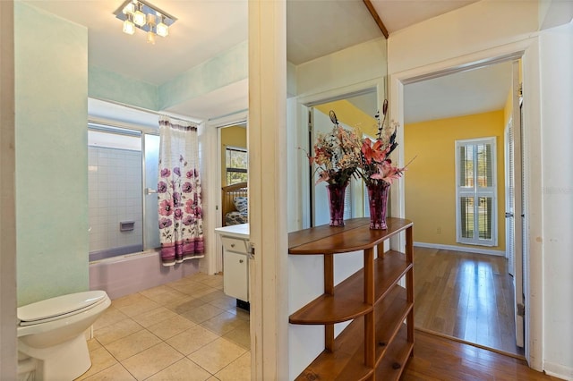 full bathroom featuring vanity, hardwood / wood-style flooring, toilet, and shower / bath combo with shower curtain