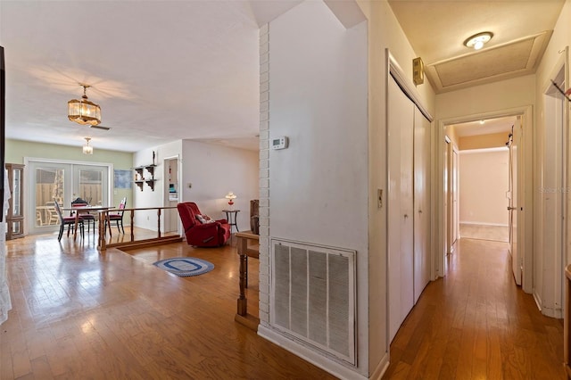 hallway featuring wood-type flooring and french doors