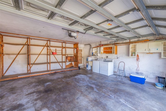 garage with independent washer and dryer, water heater, and a garage door opener