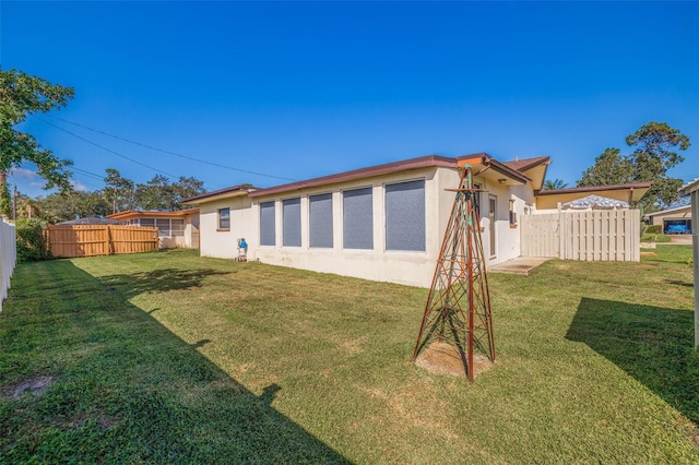 rear view of property featuring a yard