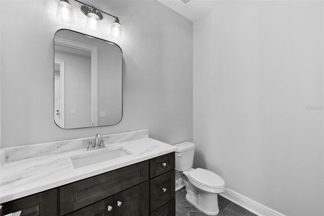 bathroom featuring vanity and toilet