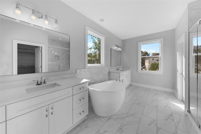 bathroom featuring vanity and shower with separate bathtub