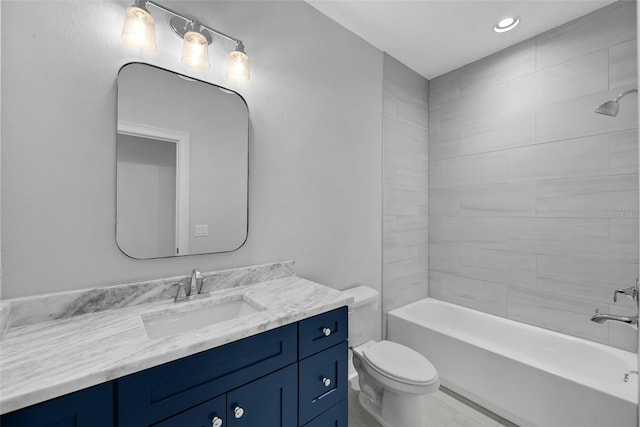 full bathroom featuring vanity, toilet, and tiled shower / bath