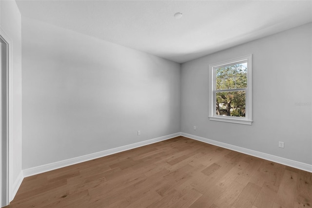 unfurnished room with light wood-type flooring