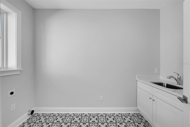 clothes washing area with sink, cabinets, and hookup for an electric dryer