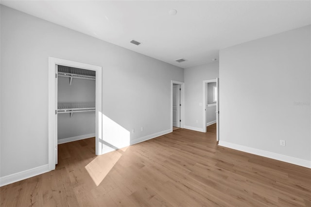 unfurnished bedroom featuring wood-type flooring and a closet