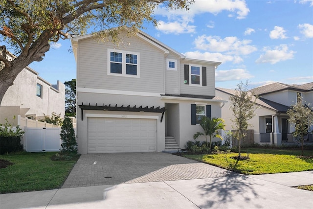 front facade with a garage and a front lawn