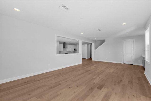 unfurnished living room with light hardwood / wood-style floors