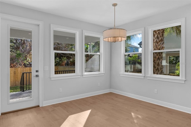 unfurnished dining area featuring light wood-type flooring