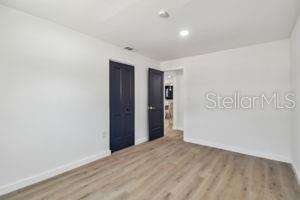 unfurnished room with light hardwood / wood-style flooring