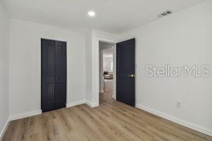 unfurnished bedroom with light hardwood / wood-style floors