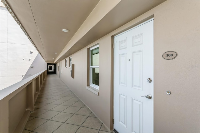 hall featuring light tile patterned floors