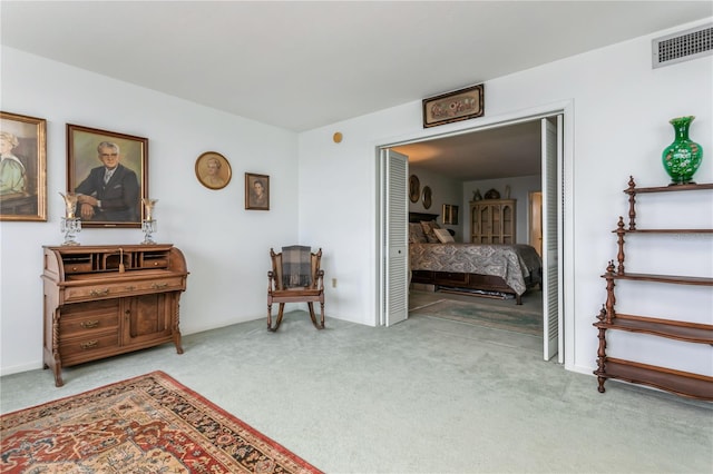 sitting room featuring light carpet