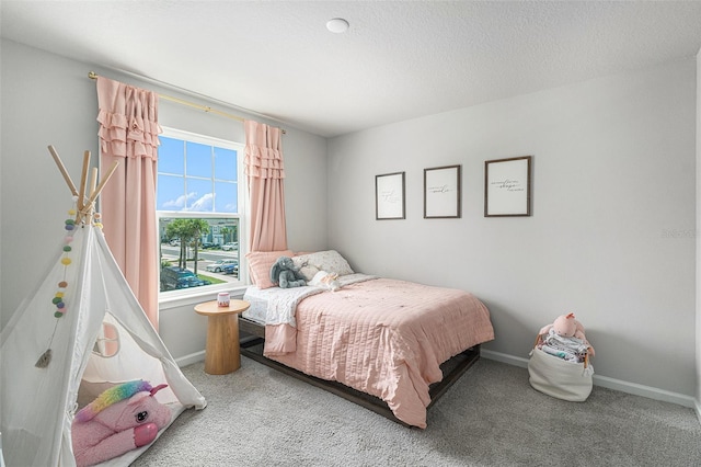 carpeted bedroom featuring a textured ceiling