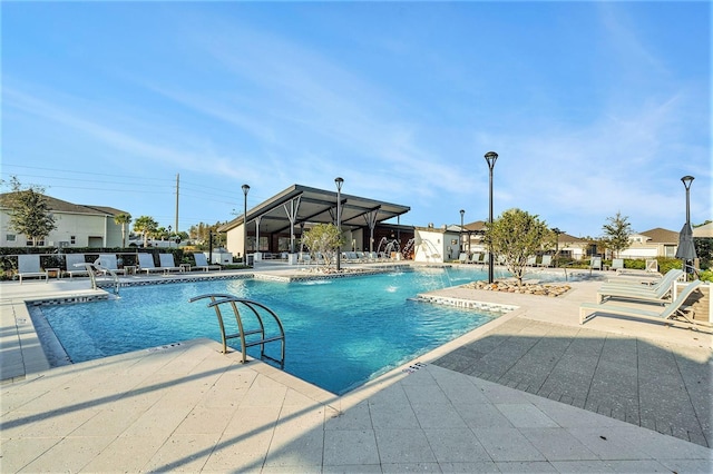 view of pool with a patio and pool water feature