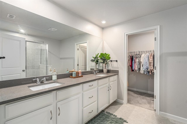 bathroom with vanity, tile patterned floors, and walk in shower