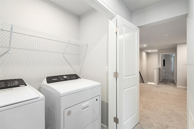 washroom with independent washer and dryer and light carpet