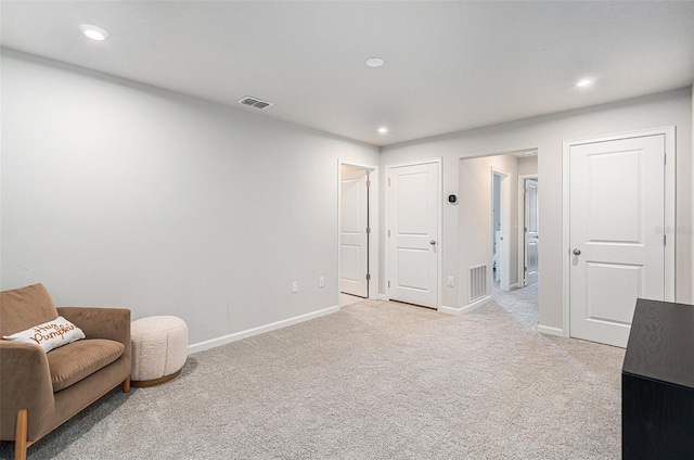 living area with light colored carpet