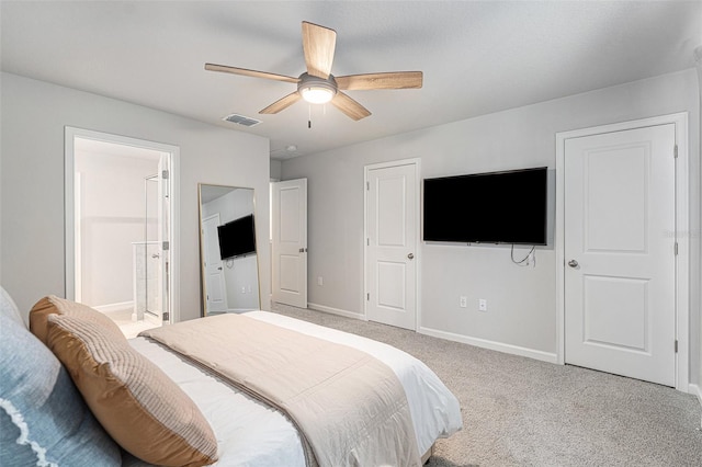 bedroom with connected bathroom, light carpet, and ceiling fan