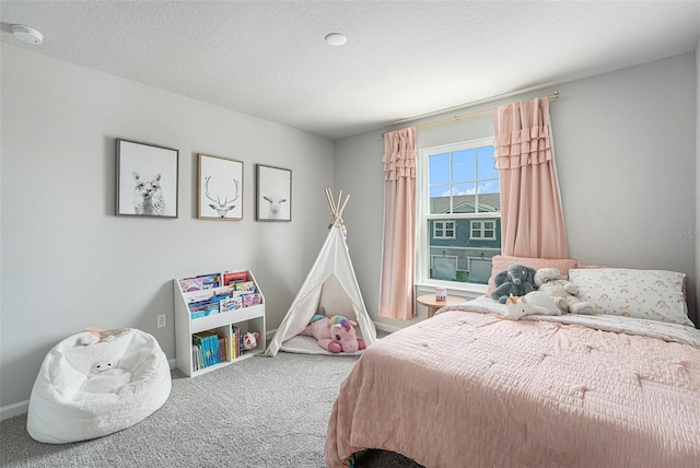 carpeted bedroom with a textured ceiling