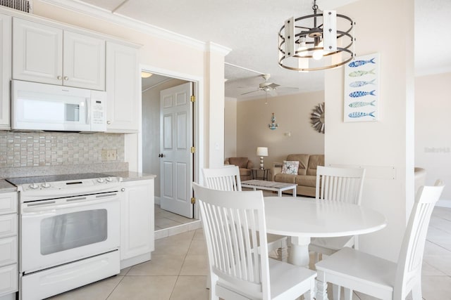 kitchen with white cabinets, decorative backsplash, light tile patterned flooring, and white appliances