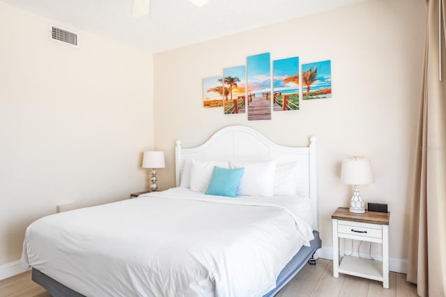 bedroom with light hardwood / wood-style floors and ceiling fan