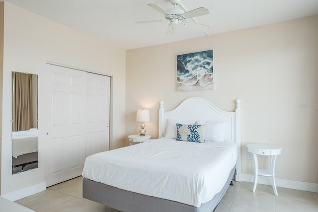 bedroom with a closet, light tile patterned floors, and ceiling fan