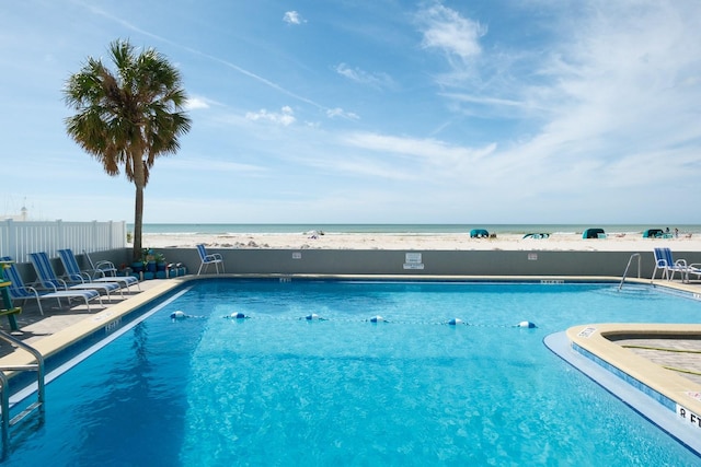 view of swimming pool with a water view