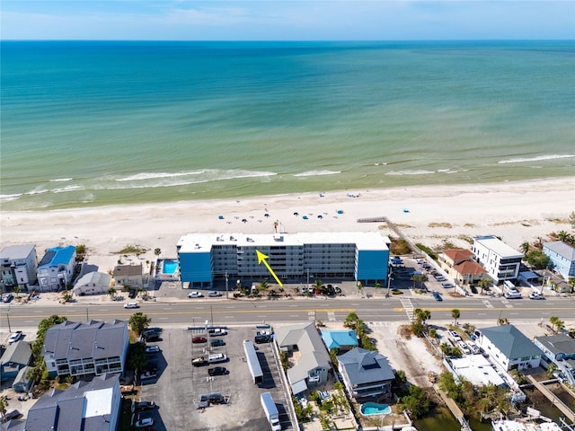 birds eye view of property with a view of the beach and a water view