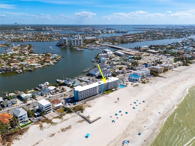 birds eye view of property featuring a beach view and a water view